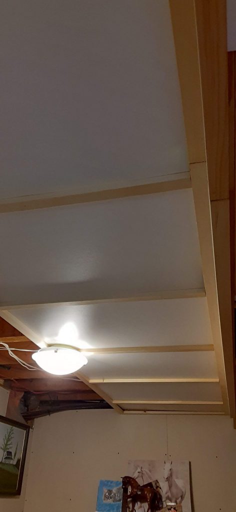 Picture of the ceiling in my studio. I created what is essentially a hanging ceiling from 1X2 wood slats and in-between I've hung hardboard, which is finished white on one side. 