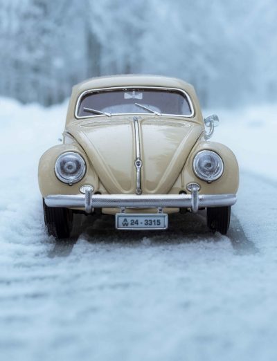 Image of a miniature Volkswagen beetle in snow.