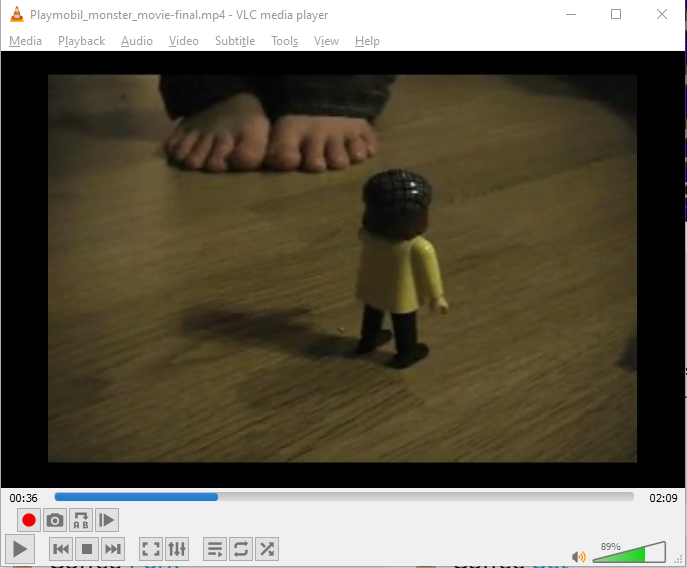 Screenshot of VLC Player shown with a screenshot from a stop-motion movie I put together with my daughter when she was around five years old or so. In the image you see a little Playmobil character and behind him, is a large pair of child's feet (my daughter's)